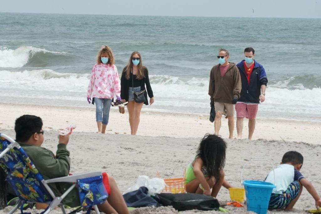 People walk along the shore at Jones Beach in Long Island, N.Y., on May 24, 2020. (Bryan R. Smith/AFP via Getty Images)