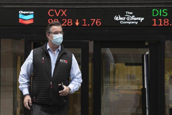 Trader Steven Capo wears a protective mask outside the New York Stock Exchange as the trading floor partially reopens in New York on May 26, 2020. (Mark Lennihan/AP Images for the New York Stock Exchange)
