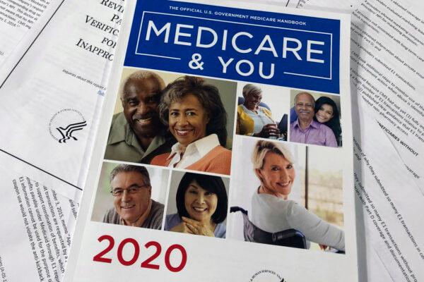 The Official U.S. Government Medicare Handbook for 2020 over pages of a Department of Health and Human Services, Office of the Inspector General report, are shown, in Washington, on Feb. 13, 2020. (AP Photos/Wayne Partlow)