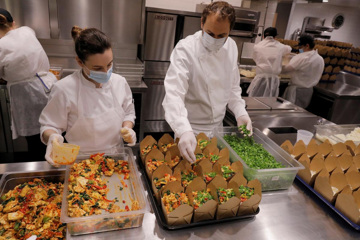Daniel Humm and his staff work in the kitchen of Eleven Madison Park to fill to-go boxes of food for donations. (REUTERS/Lucas Jackson)