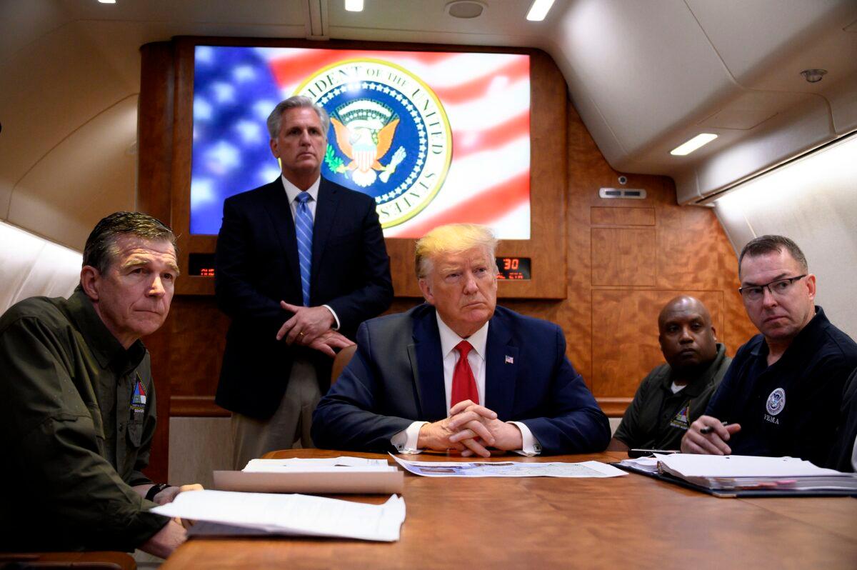 President Donald Trump, center, holds a meeting aboard Air Force One on Huricane Dorian with North Carolina Governor Roy Cooper, House Minority Leader Kevin McCarthy (R-Calif.) (standing), among others, on Sept. 9, 2019, while traveling to North Carolina. (Jim Watson/AFP via Getty Images)