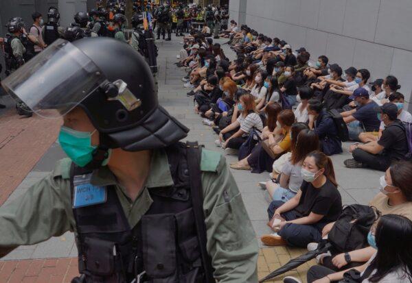 Riot police guard detained pro-democracy protesters in the Causeway Bay district of Hong Kong on May 27, 2020. (AP Photo/Vincent Yu)