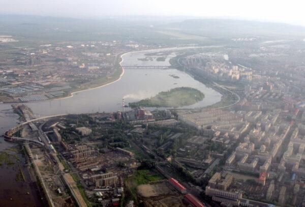 The Mudanjiang river flows through the city of Mudanjiang, China on July 6, 2006. (GOH CHAI HIN/AFP via Getty Images)