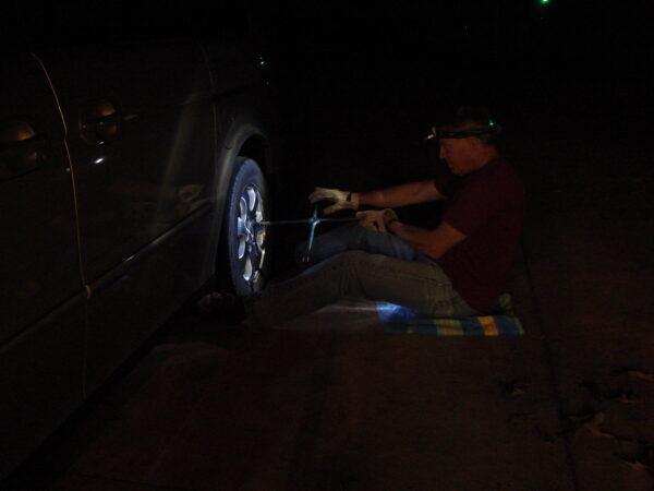 Walt Brinker changing a tire at night. (Courtesy of Walt Brinker)