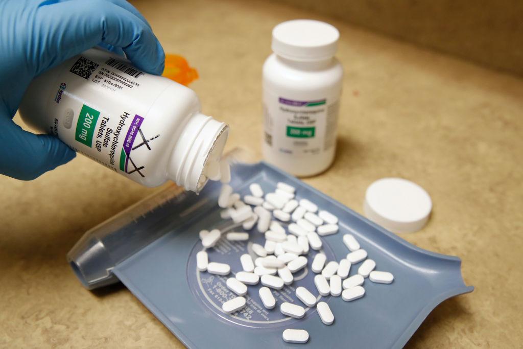 A pharmacy tech pours out pills of hydroxychloroquine at Rock Canyon Pharmacy in Provo, Utah, on May 20, 2020. (George Frey/AFP via Getty Images)
