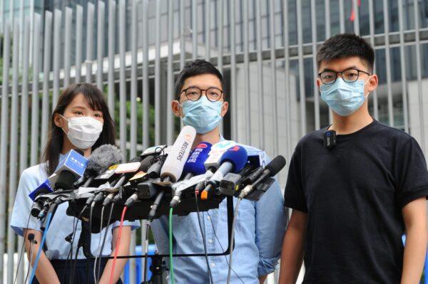 (L-R) Agnes Chow, Nathan Law, and Joshua Wong of pro-democracy party Demosistō in Hong Kong on May 28, 2020. (Song Bilung/The Epoch Times)