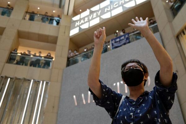 A pro-democracy demonstrator raises his hands up as a symbol of the "Five demands, not one less" during a protest against Beijing's plans to impose national security legislation in Hong Kong, on May 28, 2020. (Tyrone Siu/Reuters)