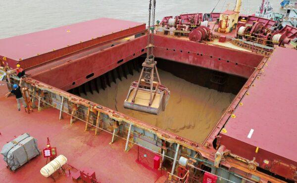 A crane bucket transferring soybeans imported from Brazil on a cargo ship at a port in Nantong in China's eastern Jiangsu Province. (STR/AFP via Getty Images)