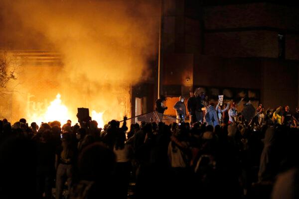 Protesters gather in front of the burning 3rd Precinct of the Minneapolis Police Department in Minn., on May 28, 2020. (Julio Cortez/AP Photo)