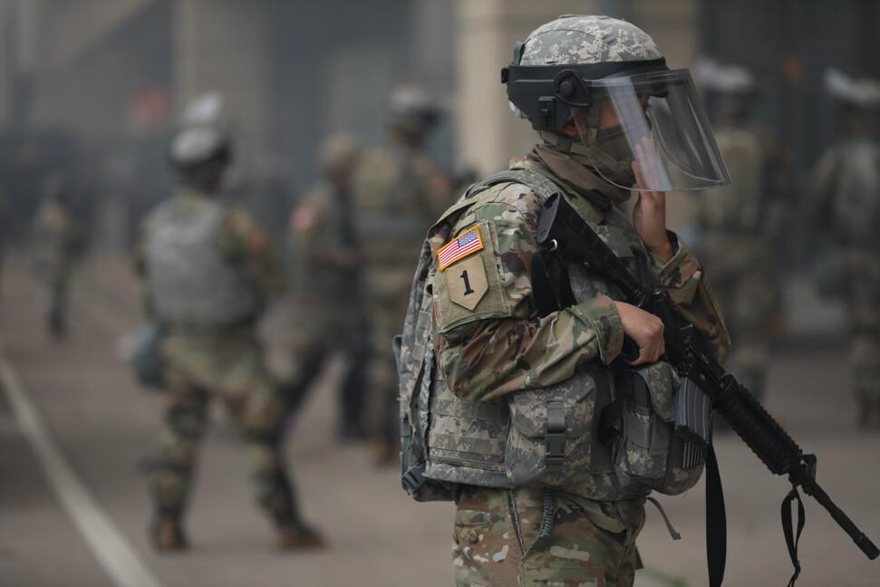 A National Guard member stands near the Lake St. Midtown metro station after a night of protests and violence following the death of George Floyd, in Minneapolis, Minn., on May 29, 2020. (Charlotte Cuthbertson/The Epoch Times)