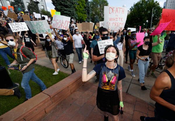 Participants march during a protest outside the State Capitol in Denver, Colorado, over the death of George Floyd, a handcuffed black man in police custody in Minneapolis, on May 28, 2020. (AP Photo/David Zalubowski)