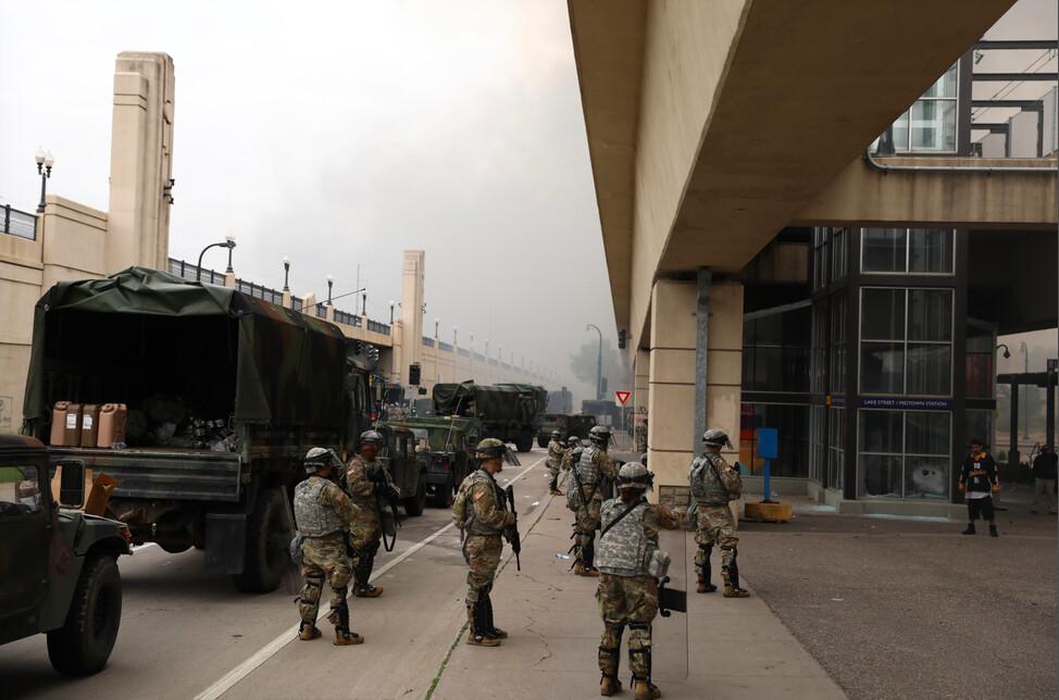 National Guardsmen stand near the Lake St. Midtown metro station after a night of protests and violence following the death of George Floyd, in Minneapolis, Minn., on May 29, 2020. (Charlotte Cuthbertson/The Epoch Times)