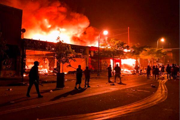 Flames rise from a liquor store and shops near the Third Police Precinct in Minneapolis, Minnesota, on May 28, 2020. (Kerem Yucel/AFP via Getty Images)