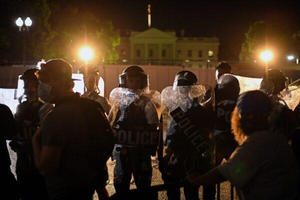 Protesters confront a row of police officers outside the White House in Washington in a demonstration over the death of George Floyd, on early May 30, 2020. (Eric Barabat/AFP/Getty Images)