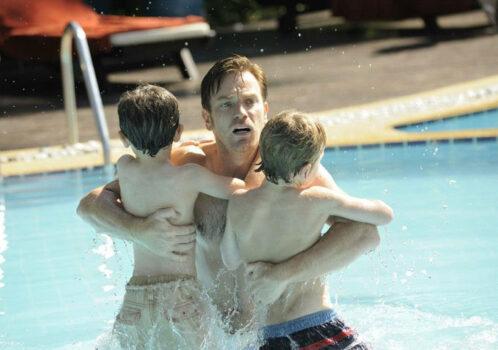 Henry Bennett (Ewan McGregor) clutching his small sons as he first sights the tsunami, in “The Impossible.” (Warner Bros. Pictures)