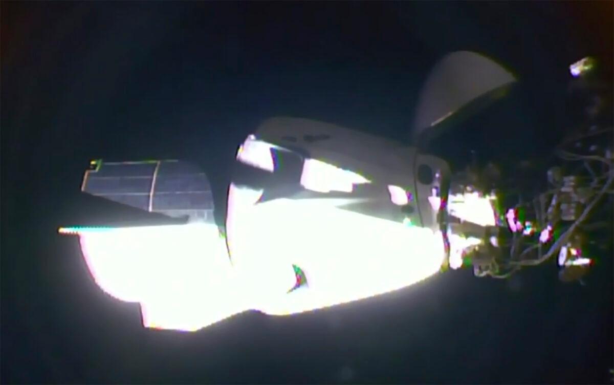 The SpaceX Dragon crew capsule, with NASA astronauts Doug Hurley and Robert Behnken aboard, docks with the International Space Station on May 31, 2020. (NASA TV via AP)