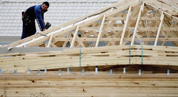 A builder works on a house under construction in a file photo. (Ian Waldie/Getty Images)