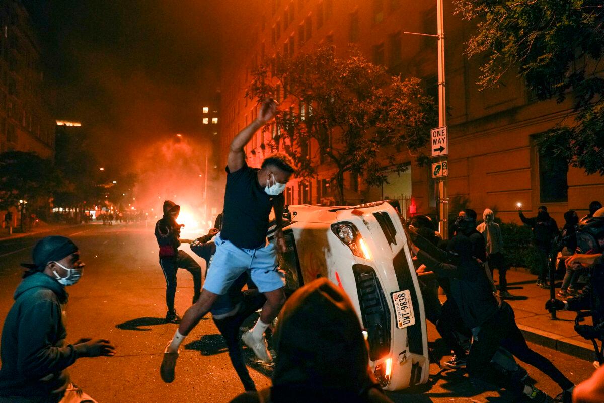 Demonstrators vandalize a car near the White House on May 31, 2020. (Evan Vucci/AP Photo)