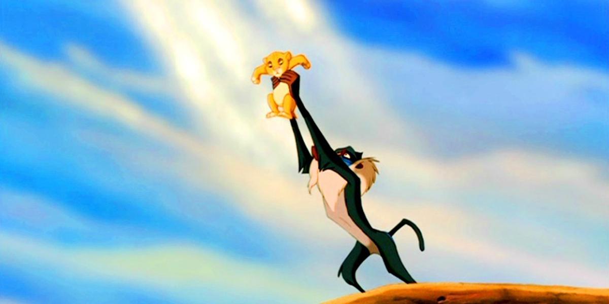The famous scene from The Lion King Circle of Life where the baboon Rafiki holds the newborn Simba. (Caters News)