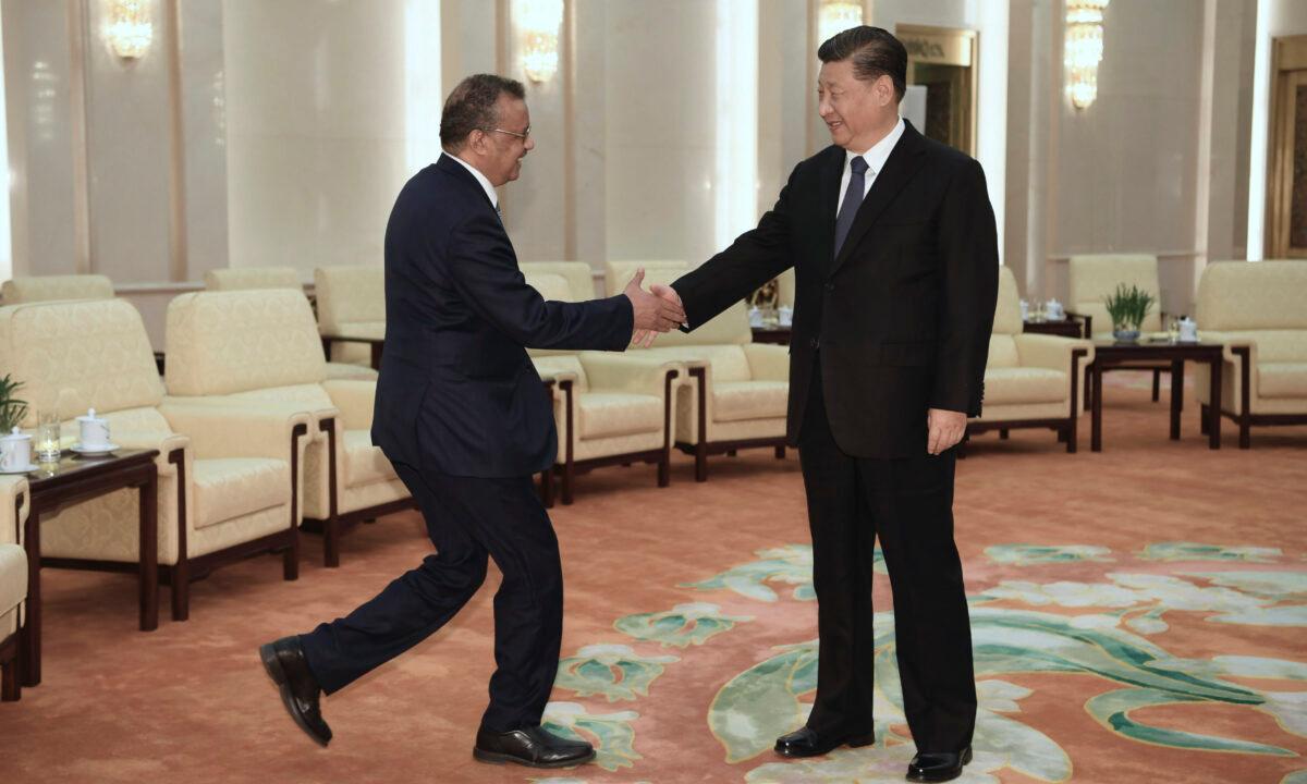 Tedros Adhanom (L), Director General of the World Health Organization, shakes hands with Chinese Leader Xi Jinping before a meeting at the Great Hall of the People in Beijing, China, on Jan. 28, 2020. (Naohiko Hatta/Pool/Getty Images)