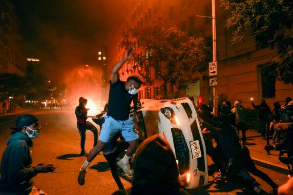 Rioters destroy a car near the White House in Washington in Washington on May 31, 2020. (Evan Vucci/AP Photo)
