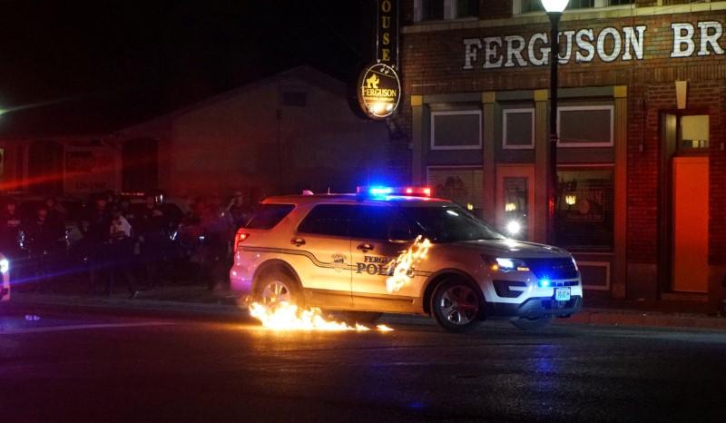 A Molotov cocktail hits a police car during a protest in Ferguson, Missouri, on May 31, 2020. (Lawrence Bryant/Reuters)