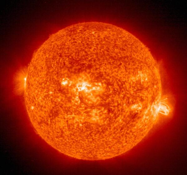 A solar flare (R) erupting from giant sunspot 649. The powerful explosion hurled a coronal mass ejection (CME) into space, but it was directed toward Earth on Aug. 19, 2004. (HO/AFP via Getty Images)