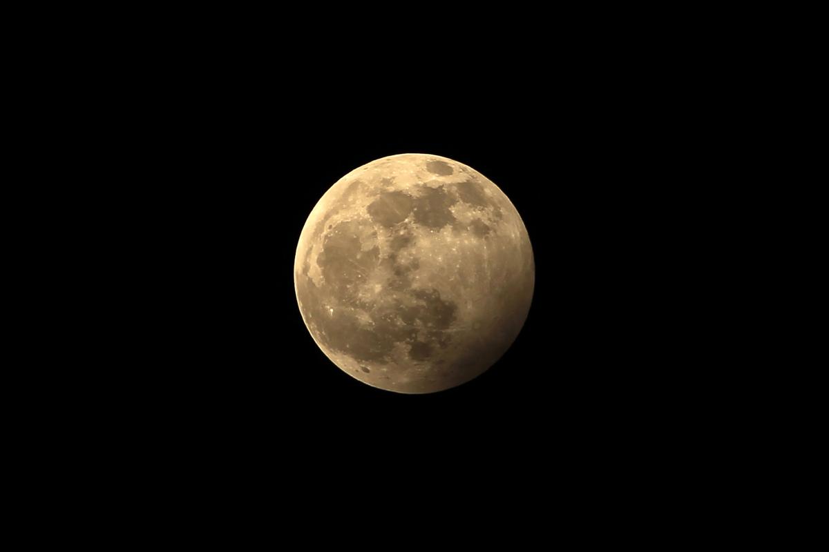 The full moon during the penumbral lunar eclipse is seen on the outskirts of Chandigarh on Jan. 11, 2020. ( VIJAY MATHUR/AFP via Getty Images)