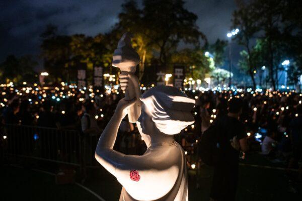 A statue of 'Goddess of Democracy' is seen amid people attending a candlelight vigil at Victoria Park to mark the 30th anniversary of the 1989 Tiananmen crackdown in Beijing, in Hong Kong, China, on June 4, 2019. (Philip Fong/AFP/Getty Images)