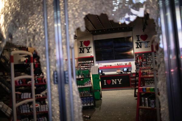 The glass door of a souvenir shop is shattered in New York on June 1, 2020. (Wong Maye-E/AP Photo)