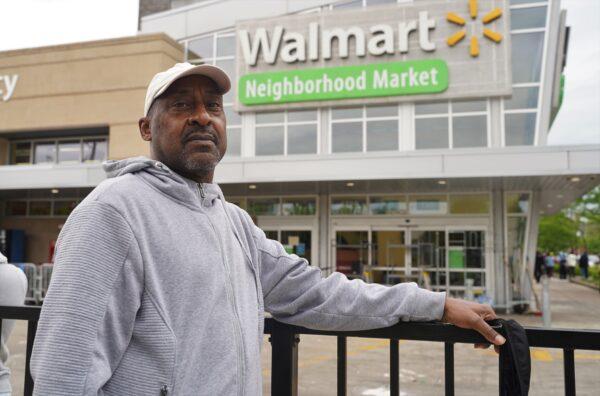 Cliff Edgeson stands in front of the Walmart, which was looted on May 31, in the Bronzeville neighborhood of Chicago, on June 1, 2020. (Cara Ding/The Epoch Times)