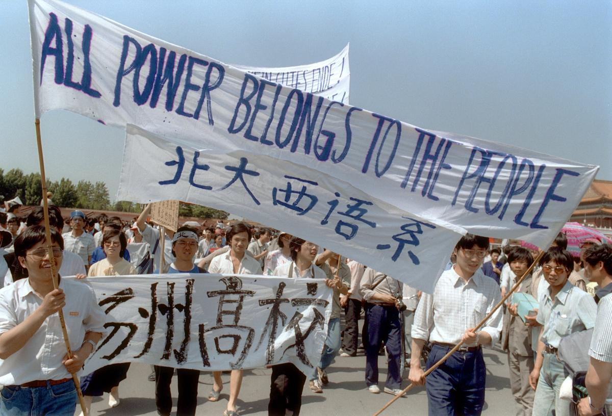 Waving banners, high school students march in Beijing streets near Tiananmen Square on May 25, 1989, during a rally to support the pro-democracy protest against the Chinese regime. (Catherine Henriette/AFP via Getty Images)