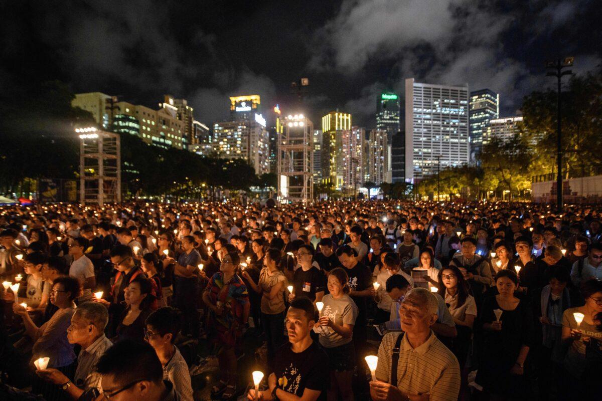 People hold candles during a vigil in Hong Kong on June 4, 2018, to mark the 29th anniversary of the 1989 Tiananmen crackdown in Beijing. (Anthony Wallace/AFP)