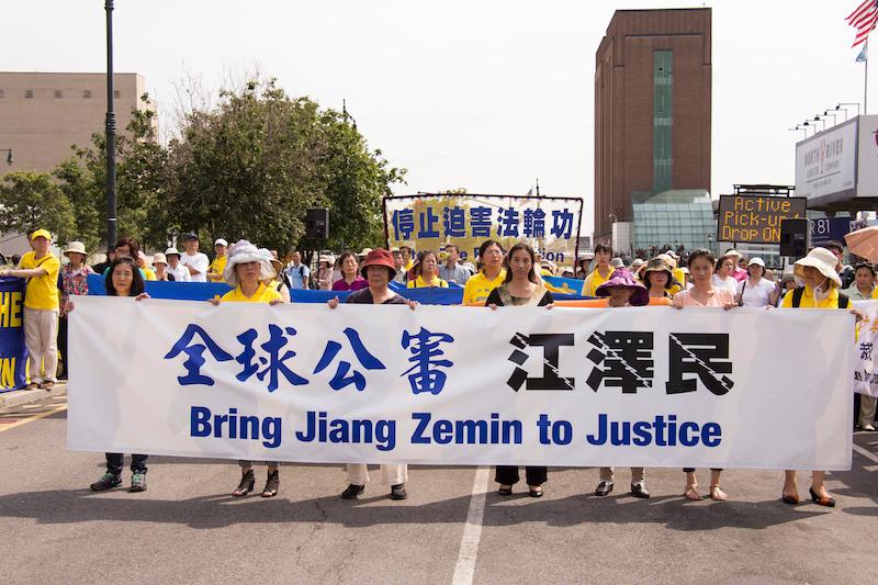 Falun Gong adherents at a rally in front of the Chinese embassy in New York City to support the global effort to sue Jiang Zemin, on July 3, 2015. (Larry Dye/The Epoch Times)