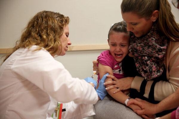 Miami Children's Hospital pediatrician Dr. Amanda Porro, M.D administers a measles vaccination to Sophie Barquin,4, as her mother Gabrielle Barquin holds her during a visit to the Miami Children's Hospital in Miami, Fla.,  on Jan. 28, 2015. (Joe Raedle/Getty Images)