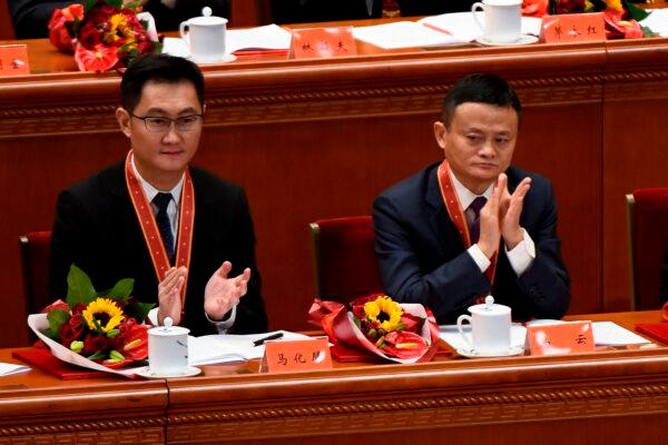 Alibaba’s co-founder Jack Ma (R) with Tencent Holdings’ CEO Pony Ma, applaud during a meeting marking the fortieth anniversary of China’s “reform and opening up” policy at the Great Hall of the People in Beijing on Dec. 18, 2018.  (Wang Zhao/AFP via Getty Images)