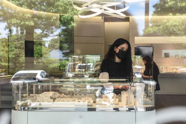 People work at a jewelry store at the Americana Mall in Manhasset, N.Y., on May 27, 2020. (Stephanie Keith/Getty Images)