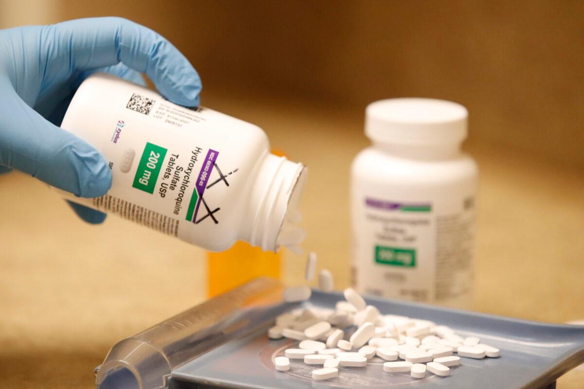 A pharmacy tech pours out hydroxychloroquine pills at Rock Canyon Pharmacy in Provo, Utah, in a file photograph. (George Frey/AFP via Getty Images)