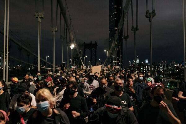 Protesters exit the Manhattan Bridge after being stopped by police for hours during a citywide curfew in New York City on June 2, 2020. (Scott Heins/Getty Images)