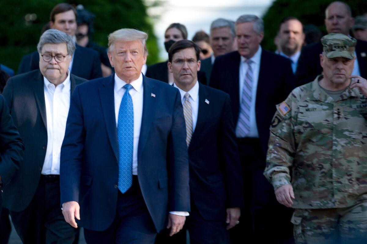 President Donald Trump walks with Attorney General William Barr (L), Secretary of Defense Mark T. Esper (C), Chairman of the Joint Chiefs of Staff Mark A. Milley (R), and others from the White House to visit St. John's Church after it was burned by rioters the night before in Washington on June 1, 2020. (Brendan Smialowski/AFP via Getty Images)