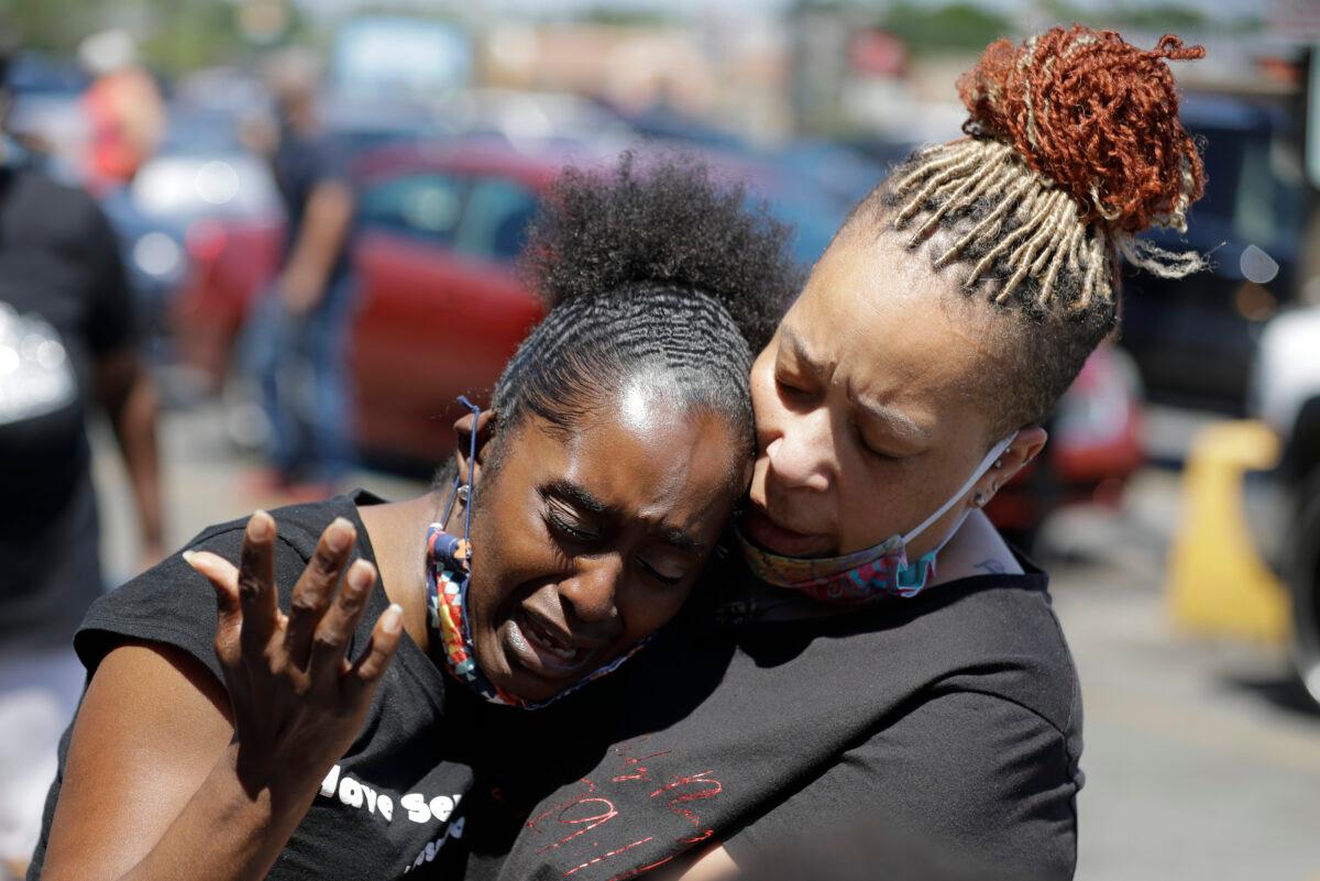 Two women pray near the intersection where David McAtee was killed Sunday evening, Louisville, Ky., on June 2, 2020. (Darron Cummings/AP Photo)