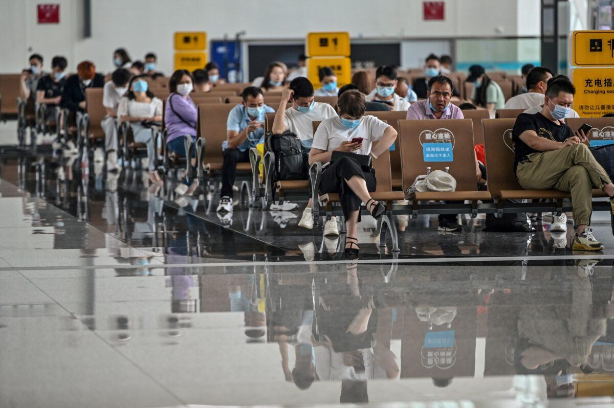 Passengers wearing protective masks sit as they wait for their flights at Tianhe Airport in Wuhan, in China's central Hubei Province, on May 29, 2020. (Hector Retamal/AFP via Getty Images)