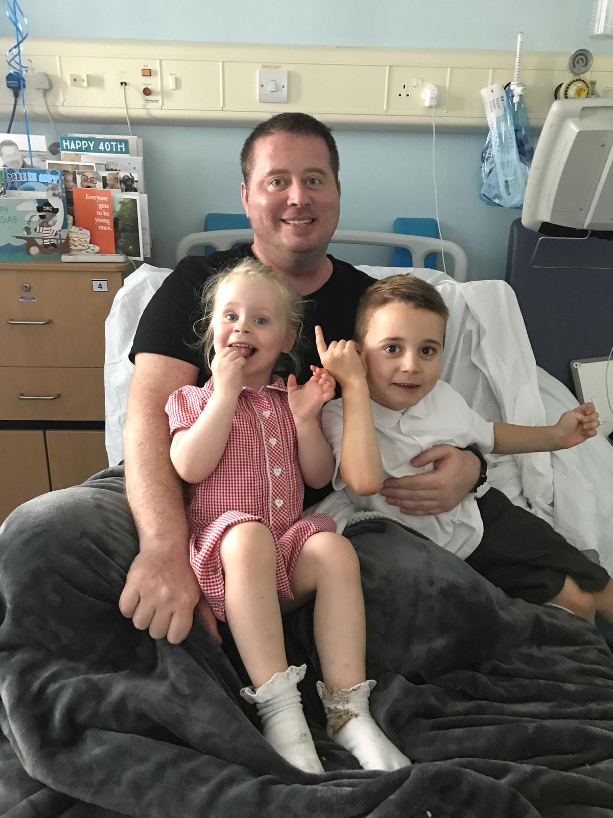 Jonathon Sheldon, 45, with his children Holland, 6, and Harrison, 8 (Caters News)