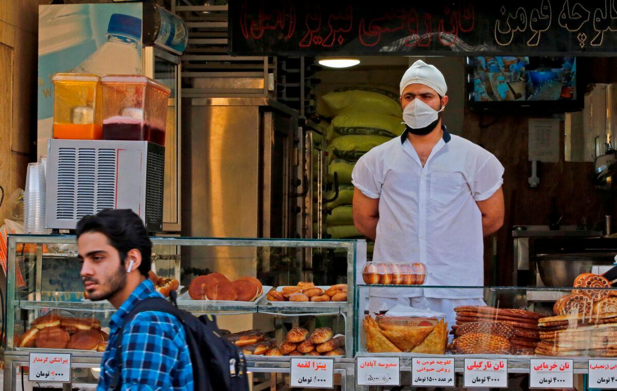 A man walks in front of a pastry shop in the capital Tehran, Iran, on June 3, 2020. (AFP via Getty Images)