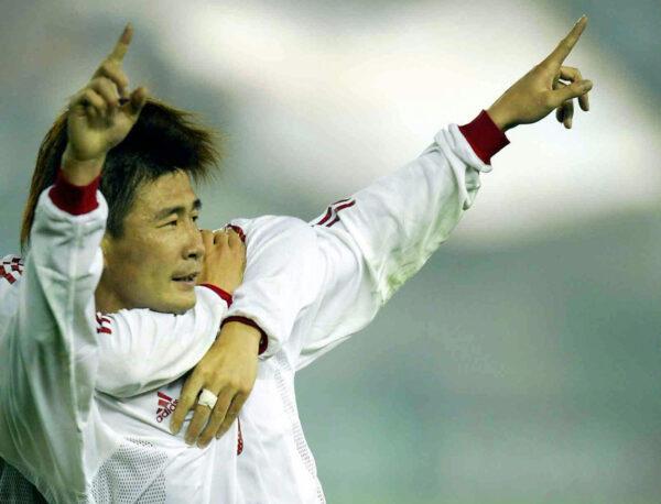 China's Hao Haidong celebrates with an unseen teammate after scoring the only goal of the match, against Kuwait during a 2006 World Cup Asian Zone Group 4 qualifying match in Guangzhou, China on Feb. 18, 2004. (STR/AFP via Getty Images)