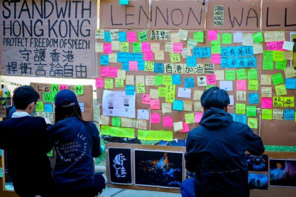 People looking at notes posted on a makeshift "Lennon Wall" to support the protests in Hong Kong, at the University of Queensland in Brisbane on August 9, 2019 shows (PATRICK HAMILTON/AFP via Getty Images)