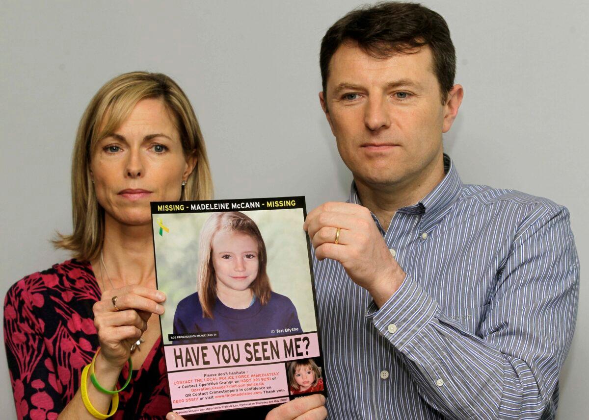 Kate and Gerry McCann pose for the media with a missing poster depicting an age progression computer generated image of their still missing daughter Madeleine during a news conference in London on May 2, 2012. (Sang Tan/AP Photo)