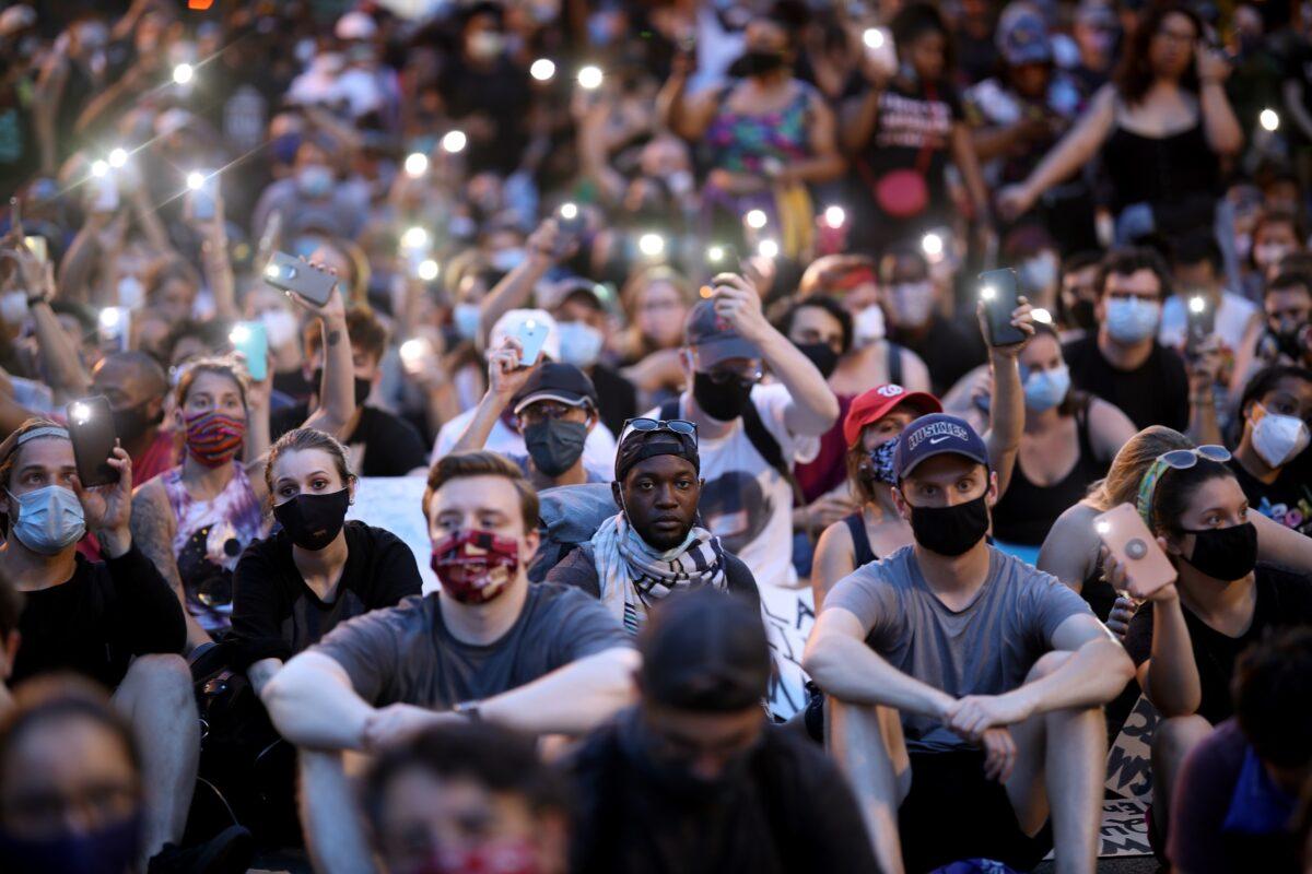 Demonstrators sing "Lean On Me" during a protest near the White House in Washington on June 3, 2020. (Win McNamee/Getty Images)