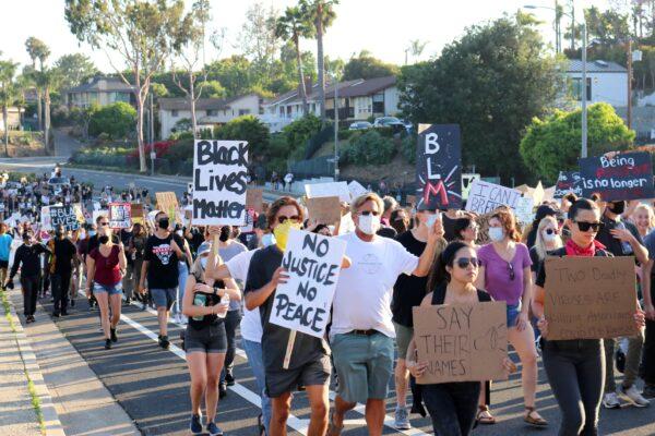Protesters march, calling for justice in the case of George Floyd, in Newport Beach, Calif., on June 3, 2020. (Jamie Joseph/The Epoch Times)