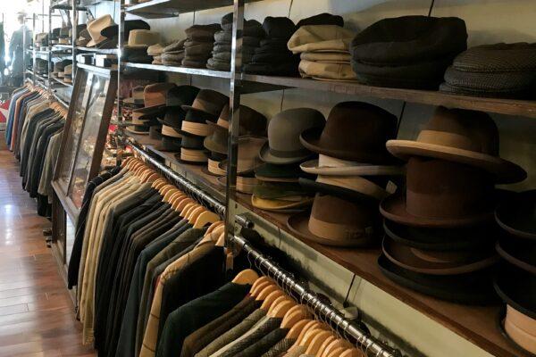 Hats line the shelves above vintage suits inside the Joyride Vintage shop in Old Towne Orange, Calif., on May 30, 2020. (Chris Karr/The Epoch Times)